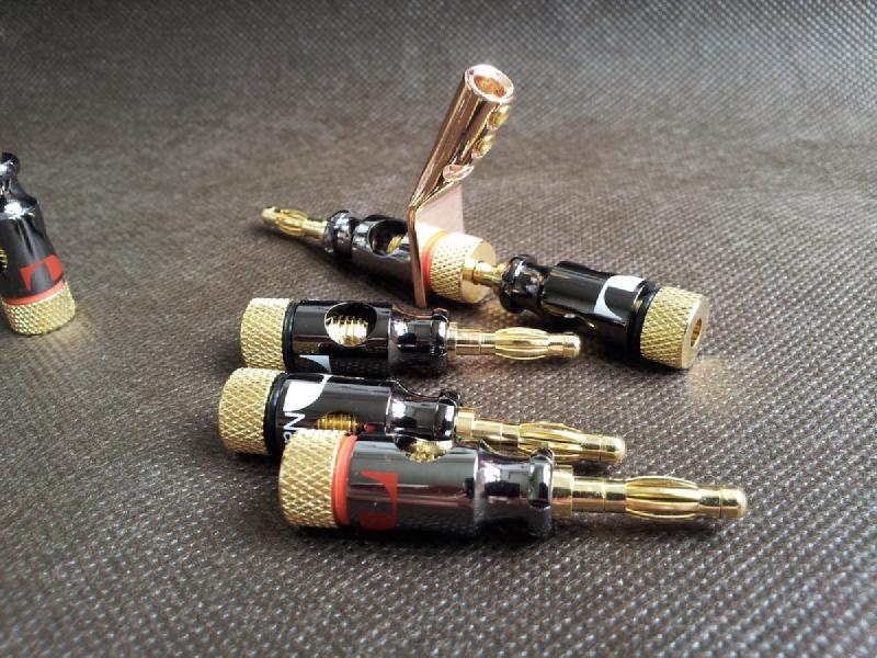 A dual banana plug adapter that allows two sets of speaker cables to connect to a single amplifier output