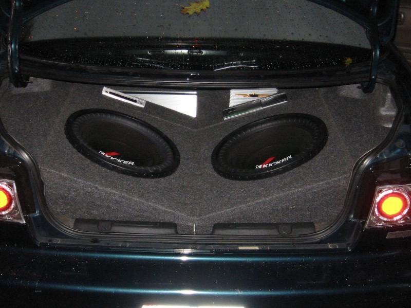 The boot of a car with a subwoofer enclosure installed, leaving limited remaining space