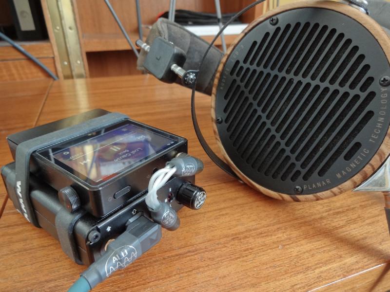 A high-end portable audio stack with an Astell&Kern AK100 player, ALO Audio International amplifier, and Audeze LCD3 headphones
