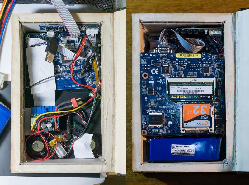 Insides of a handcrafted Myst linking book containing a Windows XP machine with 5-inch touchscreen
