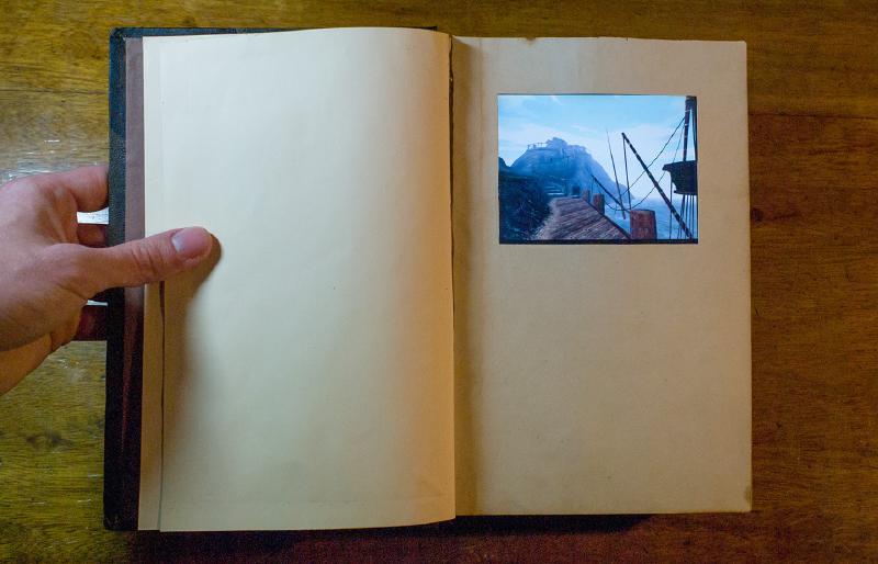 Working handcrafted Myst linking book containing a Windows XP machine with 5-inch touchscreen