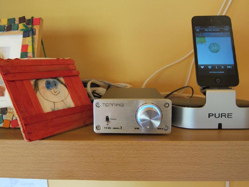 A smartphone paired with a small t-amp for a compact hi-fi setup