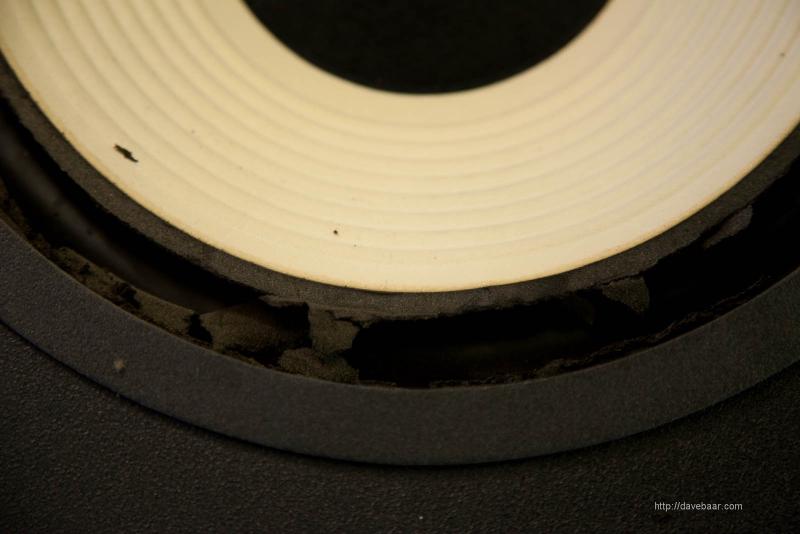 A speaker driver showing deteriorated foam surround around the woofer cone